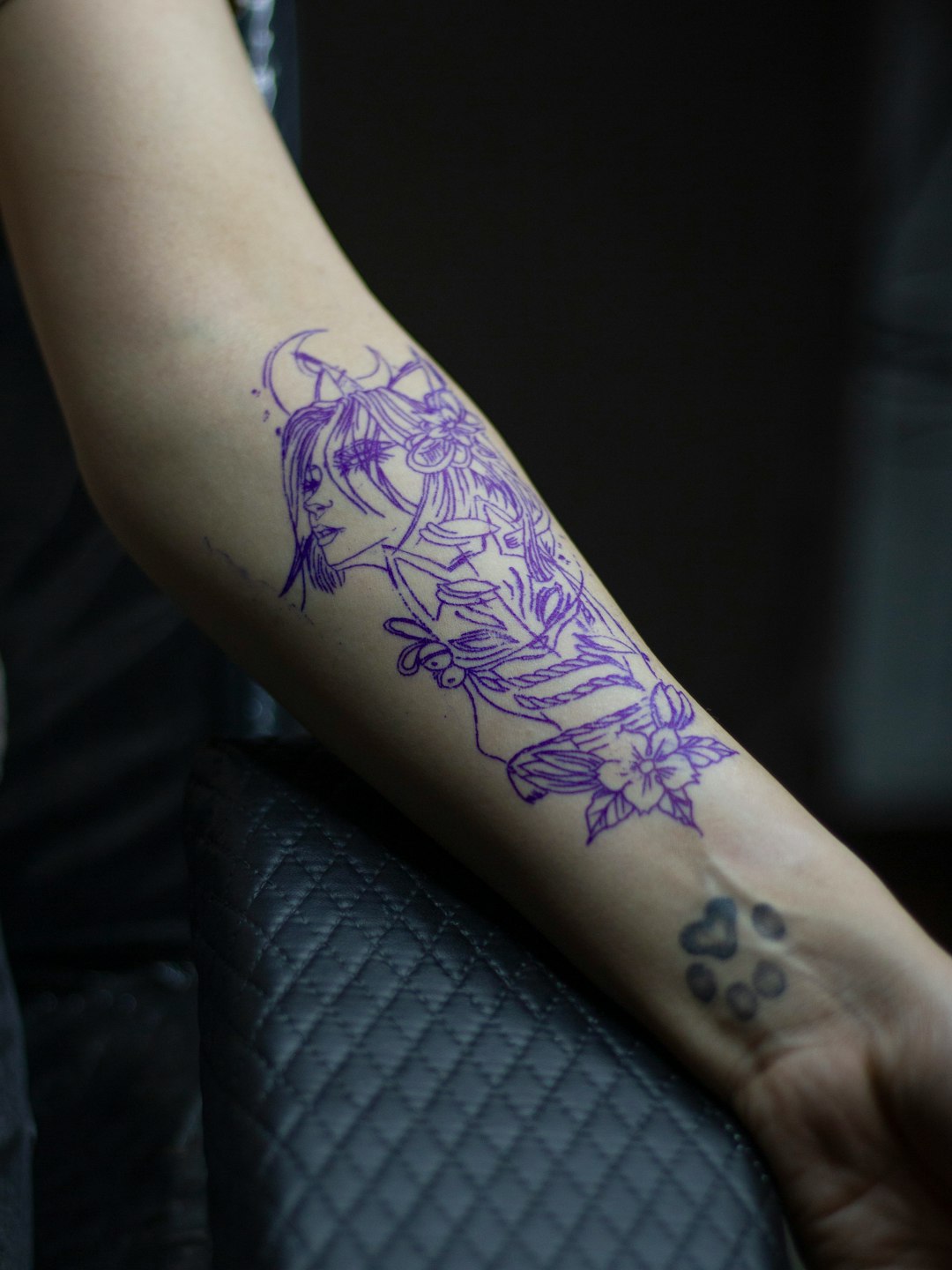 Tattoo artist tattooing.